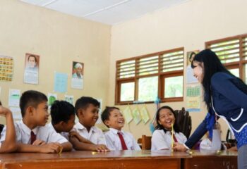Yogyakarta, Indonesia - March 16, 2015: A woman teaching the elementary students in a classroom.